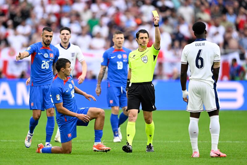 England's Marc Guehi is show a yellow card. AFP