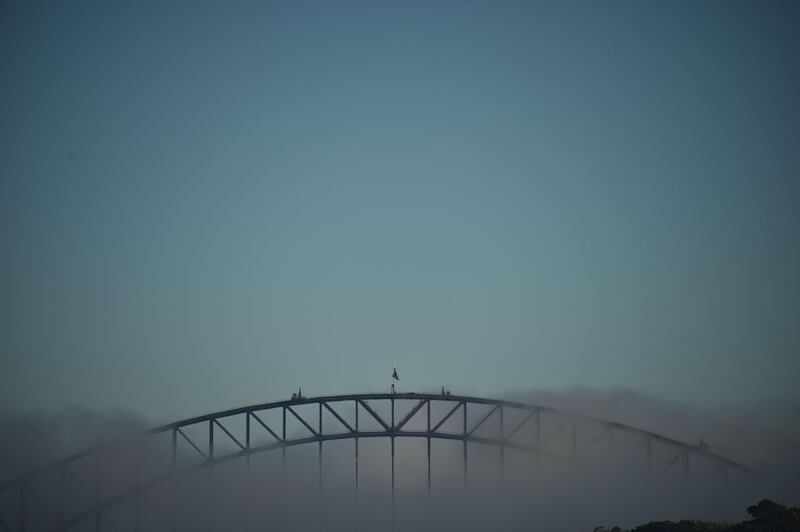 A blanket of fog covers the Harbour Bridge and Opera House in Sydney. Peter Parks/AFP