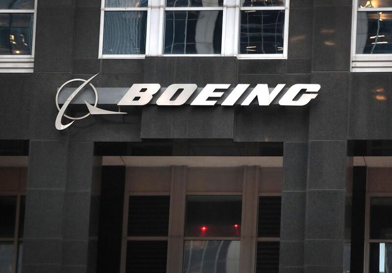 (FILES) In this file photo taken on January 29, 2020, the company logo hangs above an entrance to the headquarters of The Boeing Company in Chicago, Illinois.  Boeing plans to reduce the workforce in its civil aviation unit by 10 percent to cut costs as the coronavirus causes a crisis for airlines, two sources familiar with the matter told AFP. The layoffs would impact the unit manufacturing the 787 and 777 long-haul aircraft as well as the troubled 737 MAX, the sources said. / AFP / GETTY IMAGES NORTH AMERICA / SCOTT OLSON
