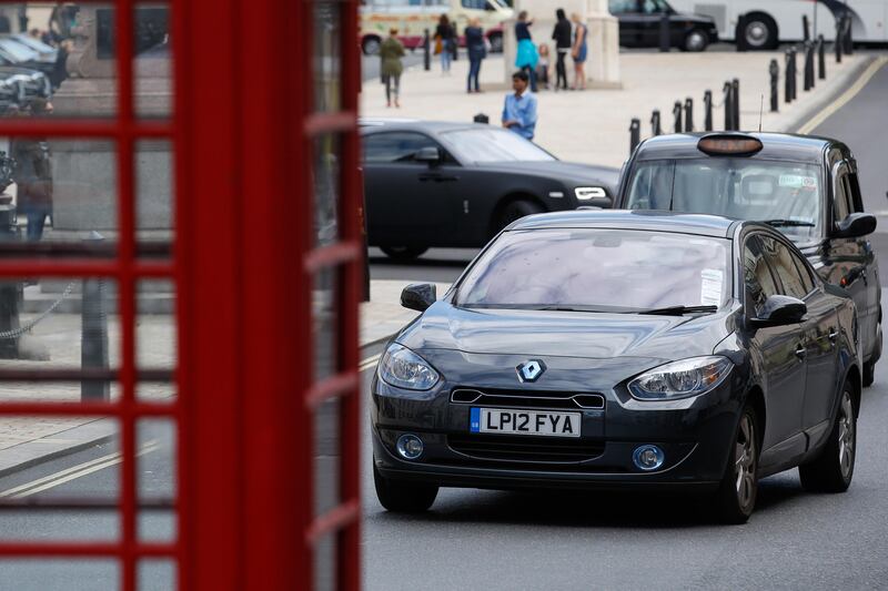 A Renault SA Fluence Z.E. electric vehicle (EV) drives through London U.K., on Thursday, Aug. 10, 2017. The U.K. government plans to invest more than 800 million pounds ($1 billion) in new driverless and zero-emission vehicle technology as it seeks to boost its economy while leaving the European Union. Photographer: Luke MacGregor/Bloomberg