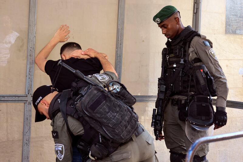 Israeli border police search a Palestinian man in Jerusalem's Old City. Reuters