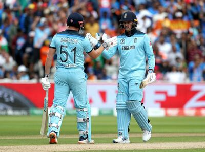 England's Jonny Bairstow, left, celebrates reaching 50 with teammate Jason Roy during the Cricket World Cup match between New Zealand and England in Chester-le-Street, England, Wednesday, July 3, 2019. (David Davies/PA via AP)