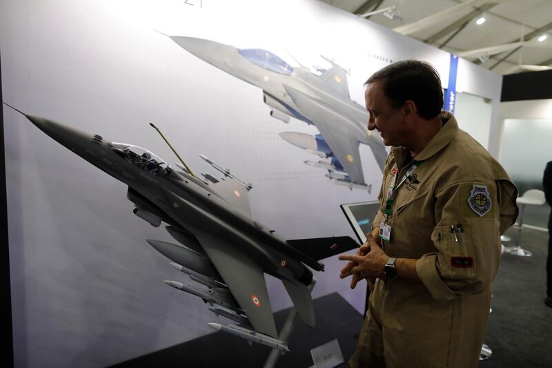 FILE - In this Feb. 5, 2020, file photo, Lockheed Martin's Robert Balserak, Lead Executive, Air Superiority Programs, explains the capabilities of the F-21 at the DefExpo in Lucknow, India. China's government said Monday, Oct. 26, 2020, it will impose sanctions on U.S. military contractors including Boeing Co.'s defense unit and Lockheed Martin Corp. for supplying weapons to rival Taiwan, stepping up a feud with Washington over security and Beijing's strategic ambitions. (AP Photo/Rajesh Kumar Singh, File)