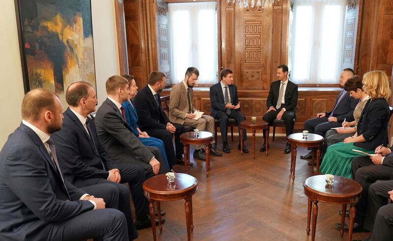 This photo released by the Syrian official news agency SANA, shows Syrian President Bashar Assad, center right, meets with Russian politicians, in Damascus, Syria, Sunday, April 15, 208. Assad says the Western airstrikes against his country were accompanied by a campaign of "lies" and misinformation in the U.N. Security Council. (SANA via AP)