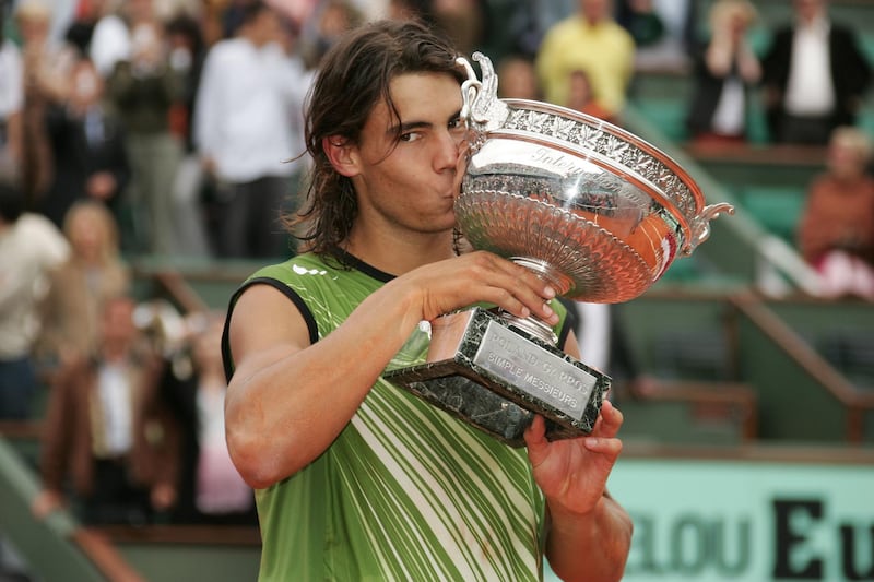 Rafael Nadal kisses the Mens Singles Trophy after his victory against Mariano Puerta in the French Open Mens Final at Roland Garros, Paris, France. Nadal won 6-7, 6-3, 6-1, 7-5.  (Photo by Stephane Cardinale/Corbis via Getty Images)