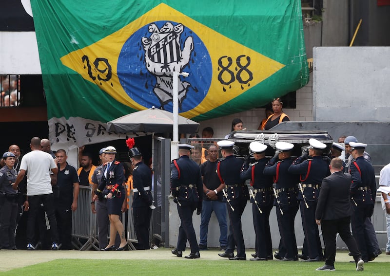 The casket of Pele is moved from Santos' Urbano Caldeira Stadium. Reuters