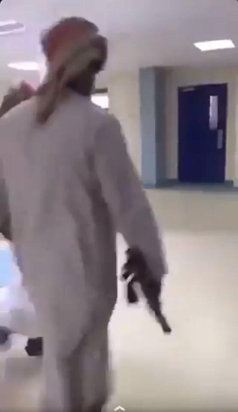 A screenshot of a video posted by Al Riyadh showing a student carrying a rifle at school.