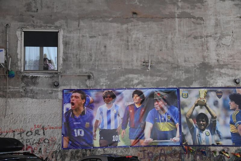 A series of posters of Diego Maradona stand out on a wall in Naples, Italy. EPA