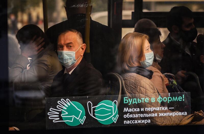 People wearing protective face masks on a bus in Moscow, Russia. EPA