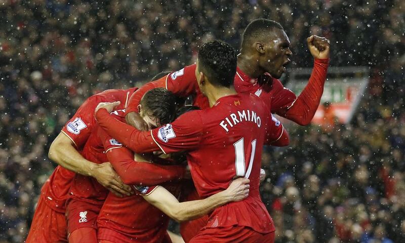 Joe Allen celebrates scoring the third goal for Liverpool with team mates. Reuters / Phil Noble