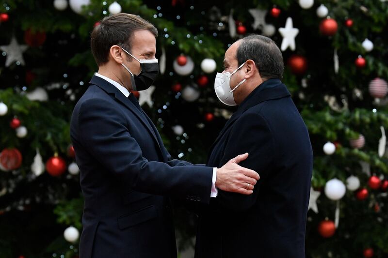 French President Emmanuel Macron welcomes his Egyptian counterpart Abdel Fattah El Sisi at the presidential palace in Paris.  AFP