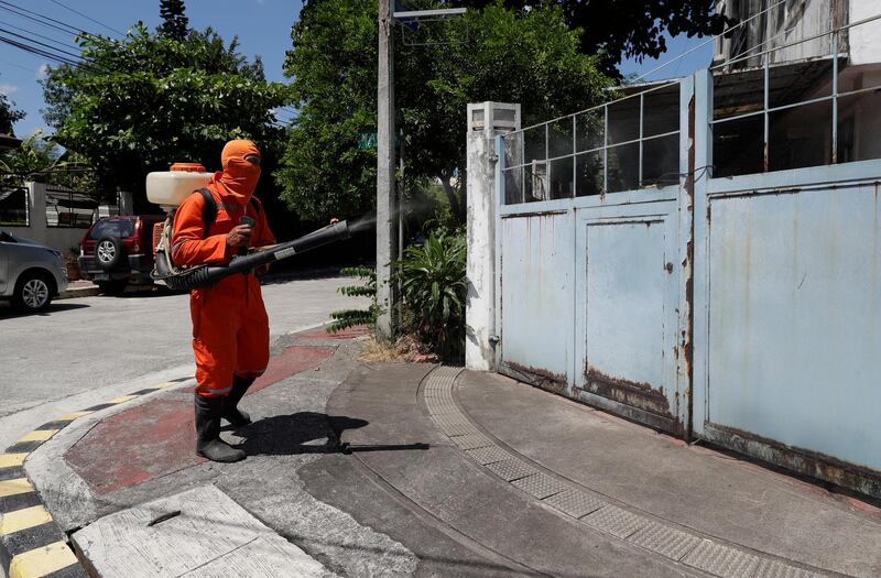 A health worker sprays disinfectant in a village in Metro Manila, the Philippines' capital region. AP Photo