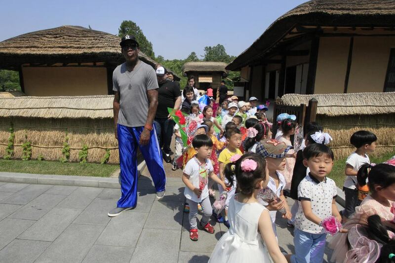 Former NBA basketball star Dennis Rodman, left, towers over North Korean children during his visit to Mangyongdae, the birth place of late North Korean leader Kim Il Sung in Pyongyang, North Korea. Rodman’s current trip is his first since Donald Trump became president. He told reporters in Beijing, as he departed for Pyongyang, that he hopes his trip will “open a door” for Trump. Kim Kwang Hyon / AP Photo