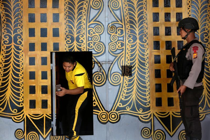 Police officers stand guard at the front door of the Banda Aceh Penitentiary in Lombaro, Banda Aceh, Indonesia. EPA