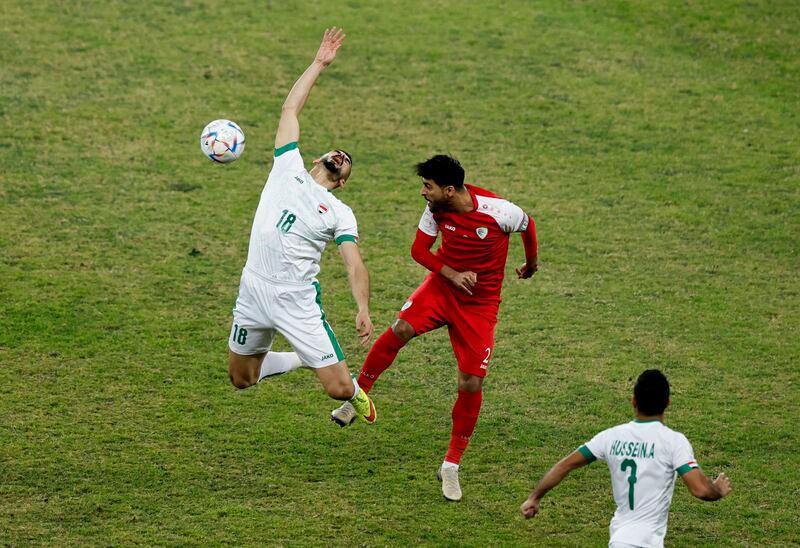 Iraq's Ayman Hussein in action against Oman's Mohamed Al Musalami. Reuters
