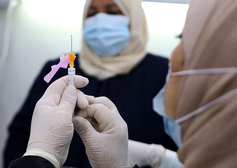 A medic prepares a Pfizer-BioTech Covid-19 vaccine injection in the capital Kuwait City. AFP