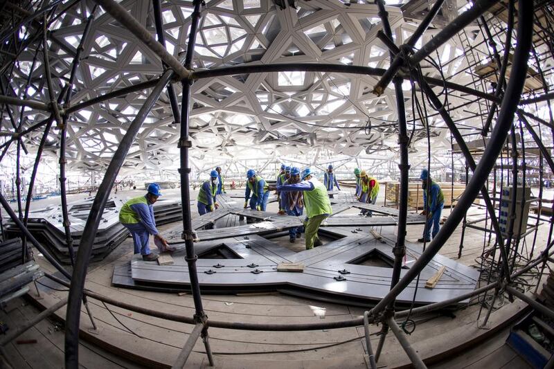 May 17, 2015: men work on the ceiling for the Louvre Abu Dhabi. Christopher Pike / The National