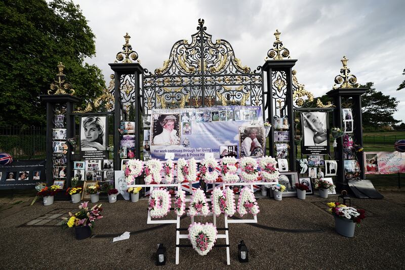 Flowers are placed at the gates outside Kensington Palace, London, the former home of Princess Diana, on the 25th anniversary of her death. PA