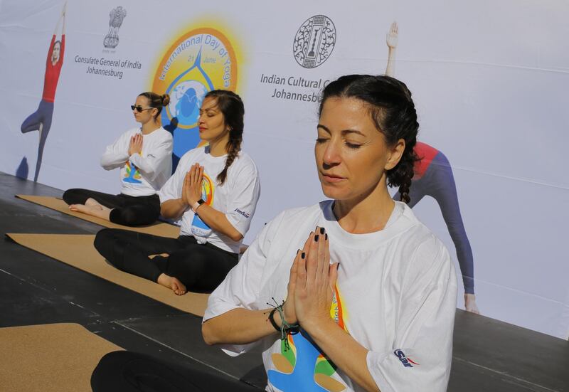 Yoga enthusiasts chant the ancient mantra 'OM' during a group class as part of an annual mass yoga event to celebrate World Yoga Day at the Wanderers Stadium in Johannesburg, South Africa. Kim Ludbrook / EPA