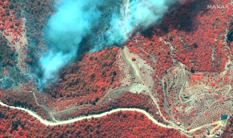 A colour infrared satellite image shows fire lines and crews battling a bushfire near Oymapinar, Turkey.