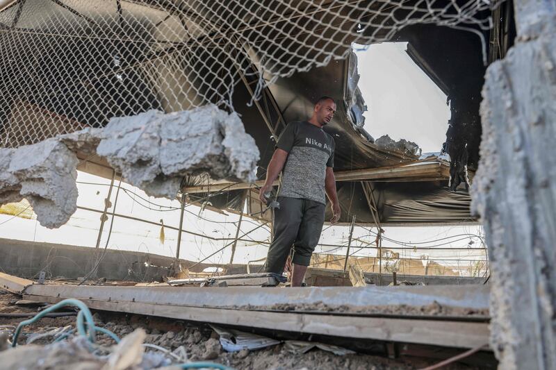 Inspecting the damage to a building in Rafah. AFP