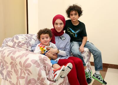 Abu Dhabi, United Arab Emirates - August 28th, 2017: Shahenda Al Bakri with her sons Aly Al Kady 7 and Abd Elrahman Al Kady 2 and a half months for a feature about how parents say that it's not easy to buy school supplies for the new term as well as prepare for Eid Al Adha with only one paycheque due to the high cost of living, high school fees and children's demands during Eid. Monday, August 28th, 2017 at Shakhbout City, Abu Dhabi. Chris Whiteoak / The National