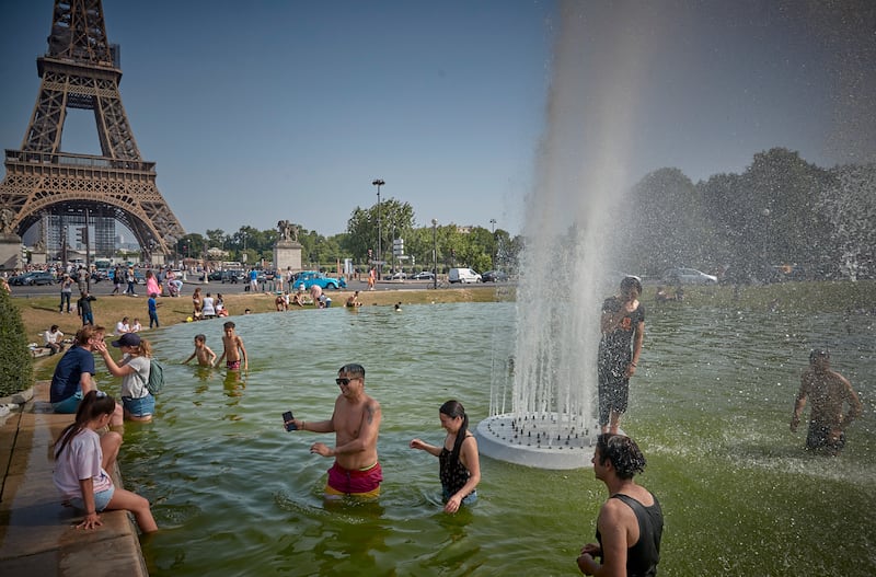 Cooling off in fountains at the Eiffel Tower. Temperatures in Paris soared towards 40°C in June 2022