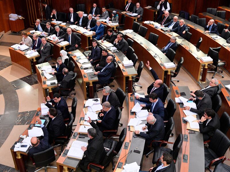 In this photo released by the Lebanese Parliament media office, Lebanese lawmakers vote for the 2020 budget at the parliament, in Beirut, Lebanon, Monday, Jan. 27, 2020. Under heavy security, Lebanese lawmakers on Monday endorsed a state budge for 2020 at a controversial session held amid a crippling financial crisis gripping the country. Outside the parliament building, protesters threw stones and sticks at security, who beat them back and detained several of the demonstrators. (AP Photo/ Hassan Ibrahim, Lebanese Parliament media office)