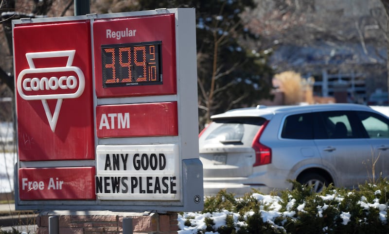 'Any good news please' sign seen along with a price for a gallon of petrol at a service station in Denver, Colorado. AP