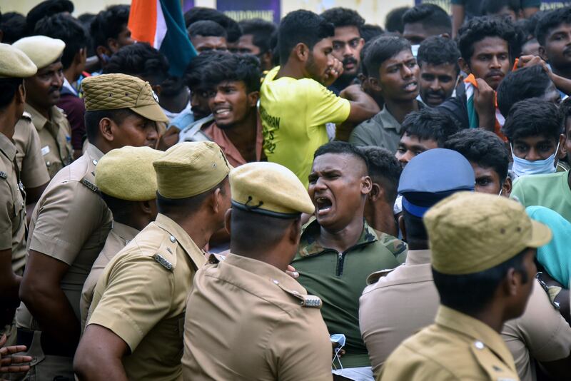 Indian police confront demonstrators protesting against a new national military recruitment policy, in the southern city of Chennai. EPA