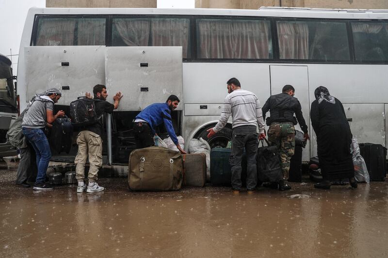 epa06717668 People, who were forcibly displaced from towns south of Damascus, arrive at Qal'aat al-Madiq crossing point in the northern countryside of Hama, Syria, 07 May 2018. The fourth batch, which included some 5000 fighters and their families and civilians from the towns of Yalda, Babbila, and Beit Saham south of Damascus, arrived to Qal'aat al-Madiq crossing point on their ways to rebels-controlled areas in northern Syria.  EPA/MOHAMMED BADRA