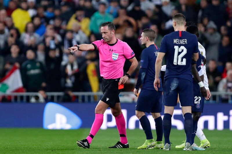 Referee Artur Dias points to the penalty box before watching the VAR monitor and cancelling his decision to award PSG a penalty. AP