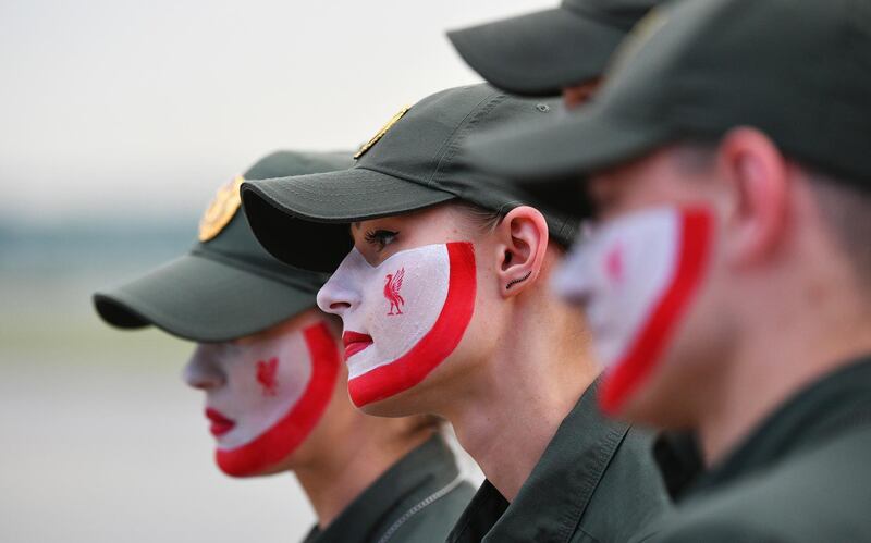 A handout photo made available by the UEFA of border guards having their faces painted in Liverpool colours at IEV Airport in Kiev, Ukraine.  EPA / UEFA / HANDOUT