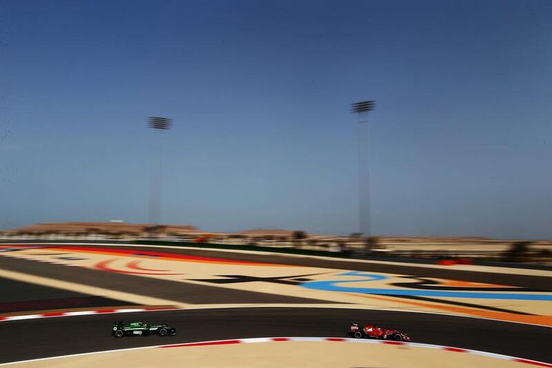 Fernando Alonso of Ferrari drives ahead of Robin Frijns of Caterham during practice for the Formula One Bahrain Grand Prix at the Bahrain International Circuit on Friday in Sakhir, Bahrain. Clive Mason / Getty Images / April 4, 2014 