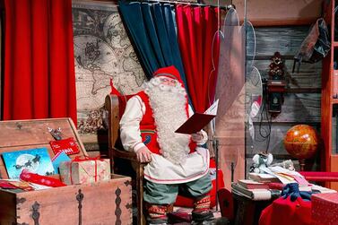 Santa Claus is pictured in his chamber behind a plexiglas screen at Santa Claus Village in the Arctic Circle near Rovaniemi, Finland October 13, 2020. Normally Santa's village in northern Finland is bustling with visitors in the months before Christmas but this year the pandemic has made them stay away, plunging the tourist attraction into crisis. Picture taken October 13, 2020. REUTERS/Attila Cser