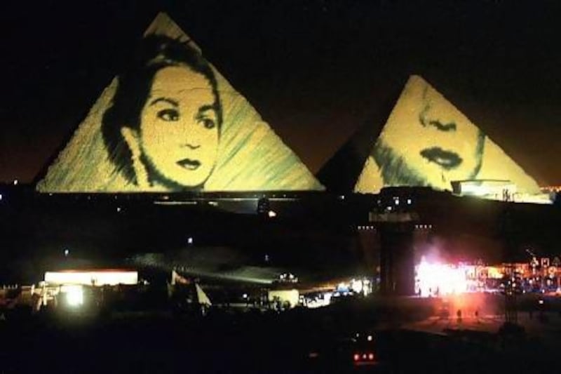 A portrait of the Egyptian diva Umm Kulthum is projected onto the Pyramids in December 1999, part of a 12-hour show by Jean-Michel Jarre to celebrate the end of the millennium.