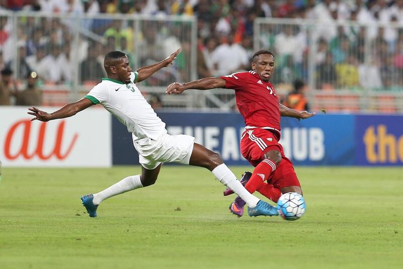 Ahmed Khalil of the UAE is tackled by Osama Hawsawi of Saudi Arabia.