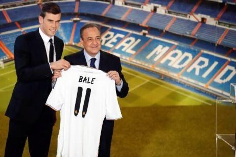 Gareth Bale with Real Madrid president Florentino Perez after completing his move to Spain. AP