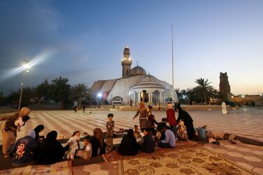 An Iraqi family eat their iftar meal at Imam Ali's Step Mosque, Basra. Reuters
