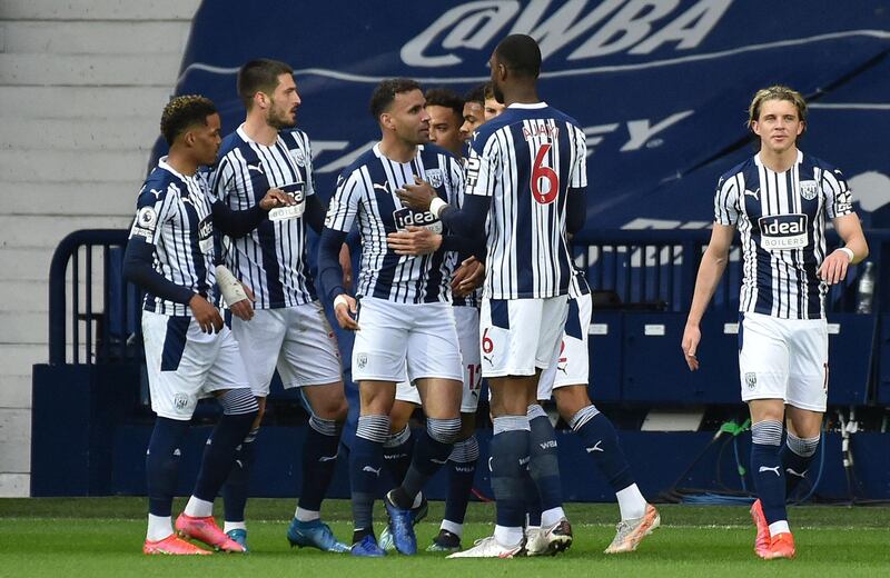 Hal Robson-Kanu, centre, celebrates with team-mates after scoring for West Brom. PA
