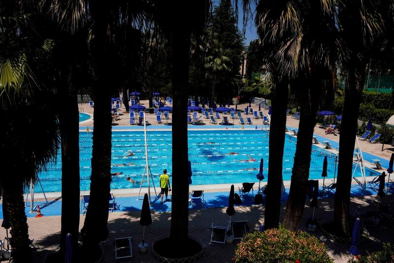 People swim in the Forum's outdoor pool. AP