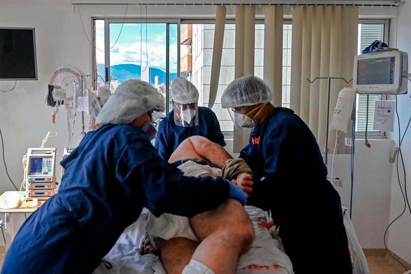 Health workers turn around a Covid-19 patient at the Intensive Care Unit of the General Hospital, in Medellin, Colombia. AFP