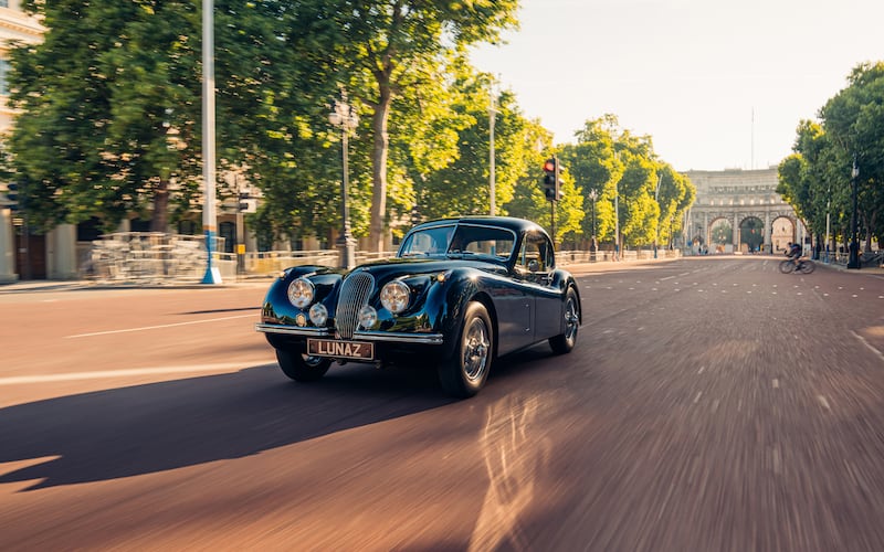 The XK120 heads down The Mall, London, in the direction of Buckingham Palace.