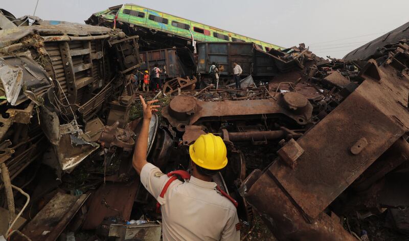 Rescuers work at the site of the crash involving three trains. EPA