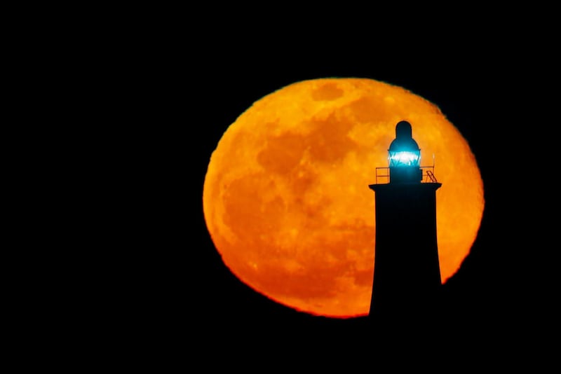 The biggest full moon of 2020 rises behind a lighthouse in Valletta, Malta. Reuters