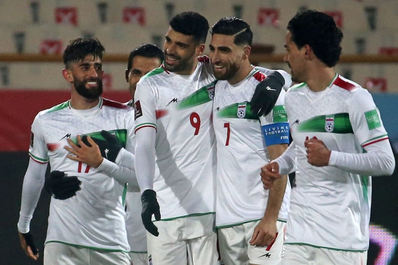 Iran forward Mehdi Taremi, centre left, celebrates after scoring. AFP