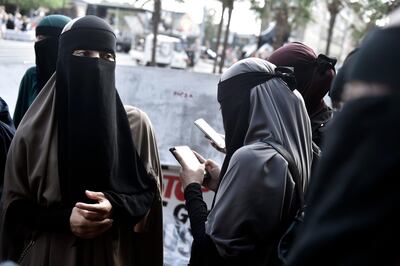 People demonstrate in Copenhagen, Denmark, Wednesday Aug. 1, 2018, as the new ban on garments covering the face is implemented. Supporters and opponents of a ban on garments covering the face, including Islamic veils such as the niqab or burqa, clashed verbally Wednesday as the law takes effect. (Mads Claus Rasmussen/Ritzau Scanpix via AP)