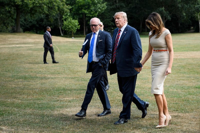 US President Donald Trump and First Lady Melania Trump walk with US Ambassador to the United Kingdom Woody Johnson as they arrive at the US ambassador's residence Winfield House in London. AFP