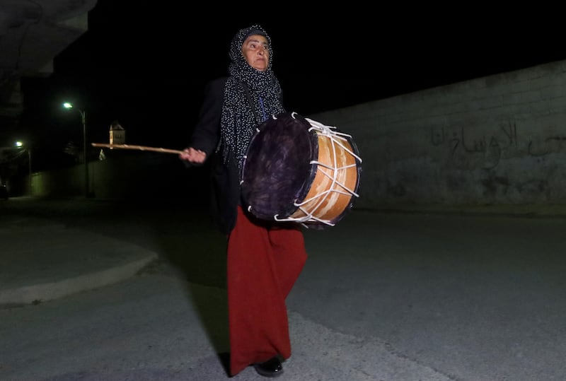A drummer walks along a street in Enfidha, Tunisia, to wake Muslims for their predawn meals. Reuters