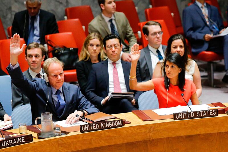 US Ambassador to the United Nations Nikki Haley (R) and Britain's Ambassador Matthew Rycroft vote on a US-drafted resolution toughening sanctions on North Korea, at the United Nations Headquarters in New York, on August 5, 2017.  / AFP PHOTO / EDUARDO MUNOZ ALVAREZ